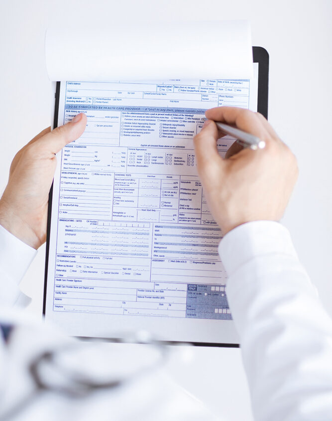 close up of male doctor holding prescription paper in hand